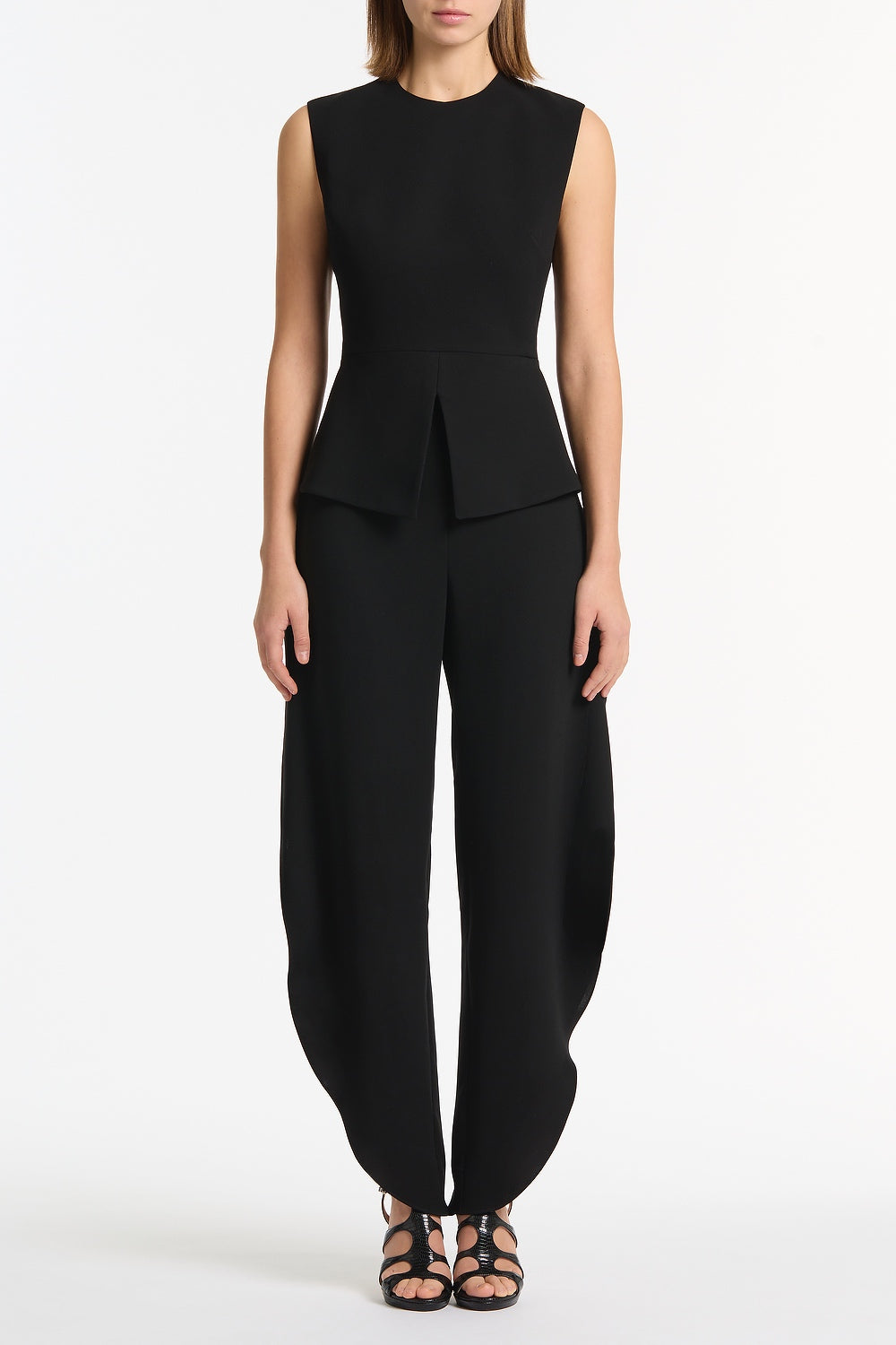 Image of a model wearing Tops. Product name - Black Crepe Peplum Top in Black colour by brand - Carla Zampatti