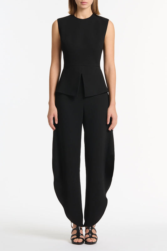 Image of a model wearing Tops. Product name - Black Crepe Peplum Top in Black colour by brand - Carla Zampatti