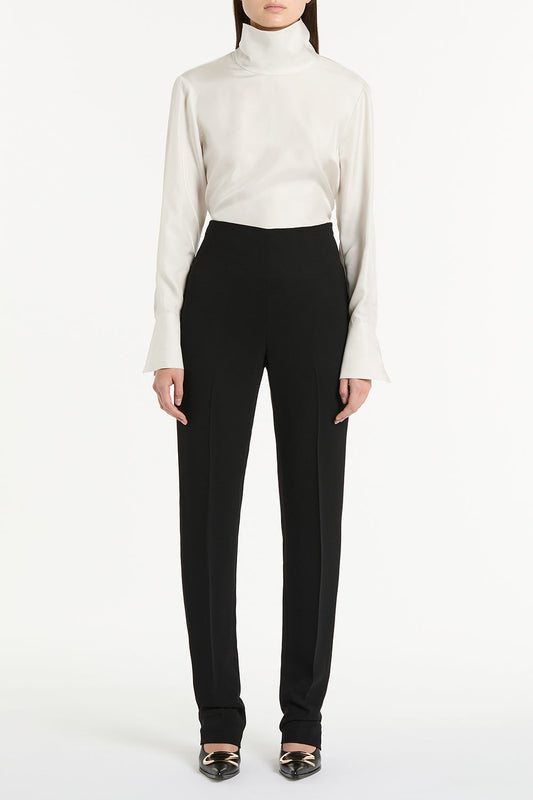 Image of a model wearing Pants. Product name - Black Crepe Slim Classic Pant in Black colour by brand - Carla Zampatti