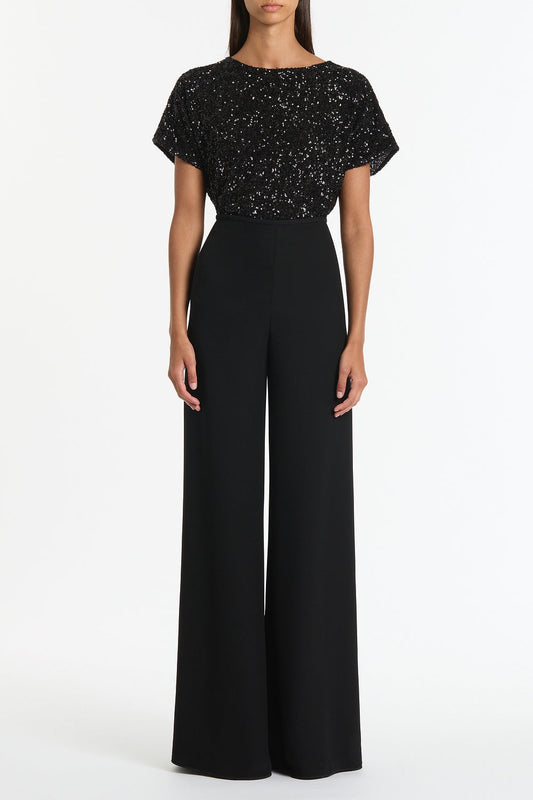 Image of a model wearing Tops. Product name - Black Crushed Sequin Drape Top in Black colour by brand - Carla Zampatti