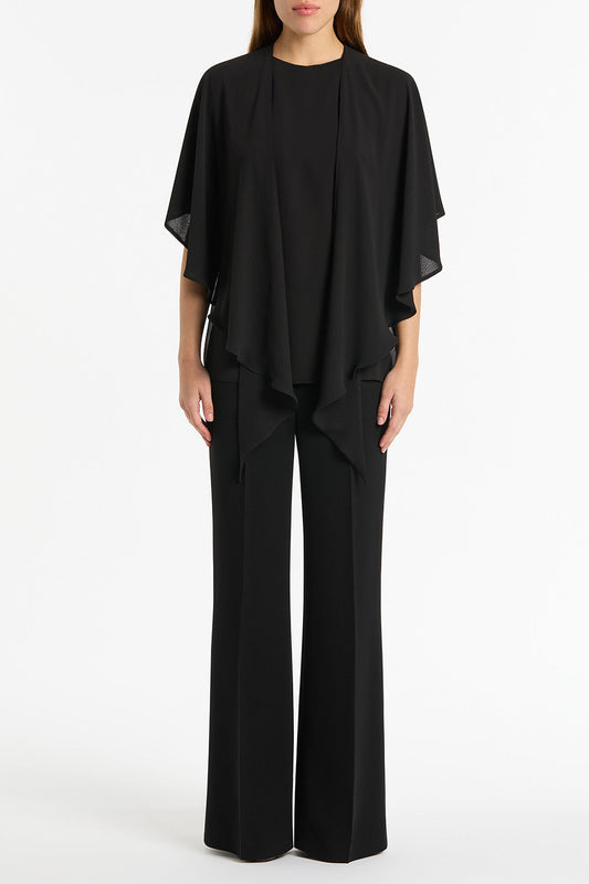Image of a model wearing Tops. Product name - Black Georgette Cascata Top in Black colour by brand - Carla Zampatti