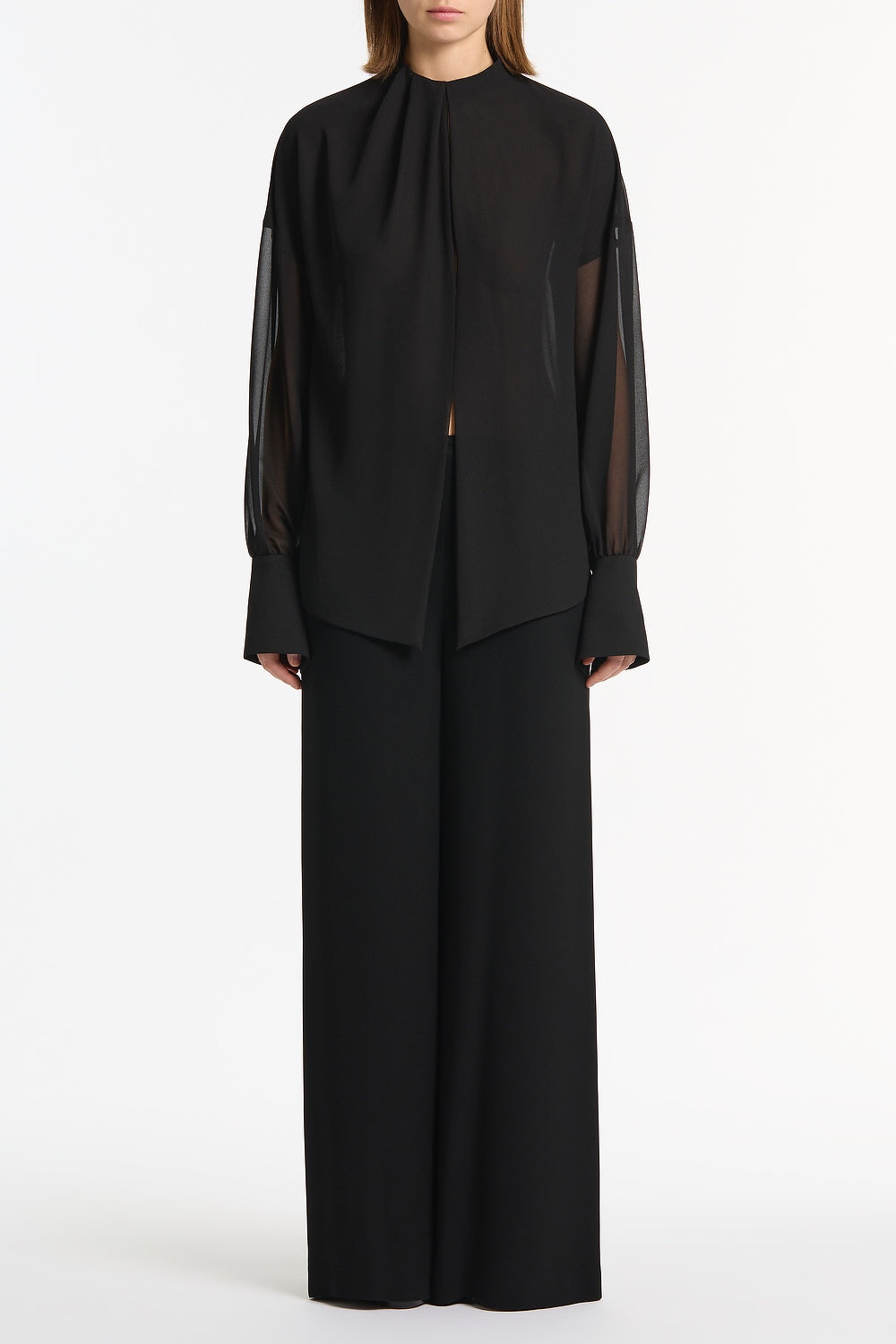 Image of a model wearing Tops. Product name - Black Georgette Drop Sleeve Blouse in Black colour by brand - Carla Zampatti