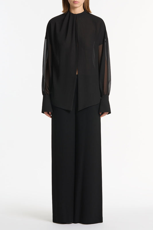 Image of a model wearing Tops. Product name - Black Georgette Drop Sleeve Blouse in Black colour by brand - Carla Zampatti