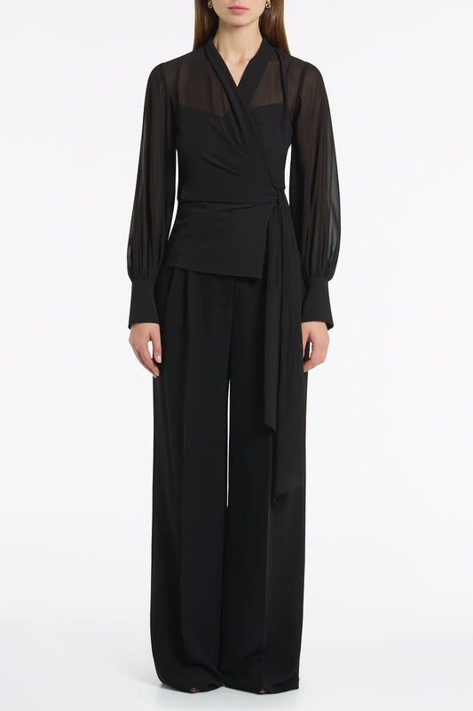 Image of a model wearing Tops. Product name - Black Georgette Long Sleeve Wrap Blouse in Black colour by brand - Carla Zampatti