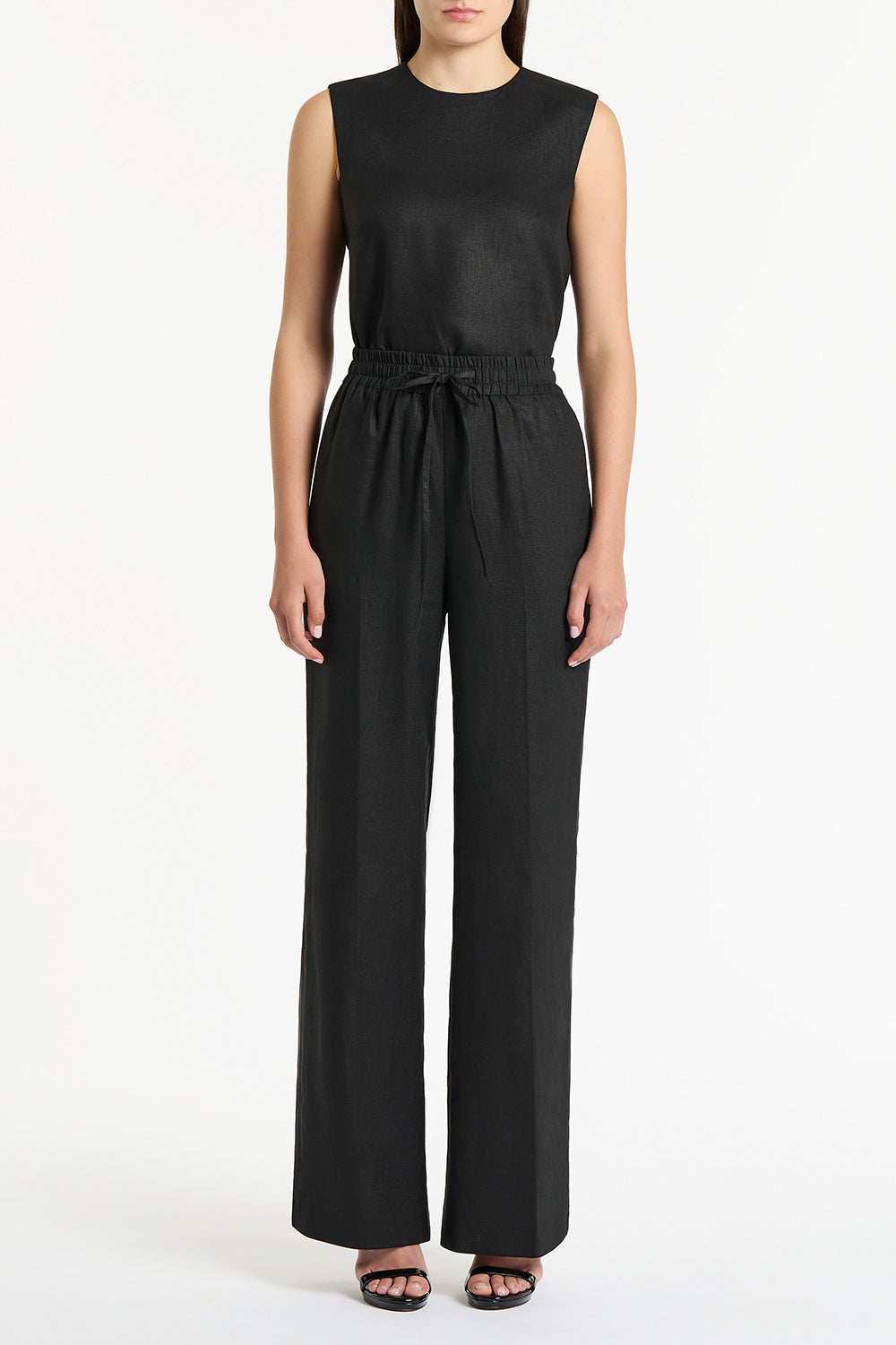 Image of a model wearing Pants. Product name - Black Linen Lounge Pant in Black colour by brand - Carla Zampatti