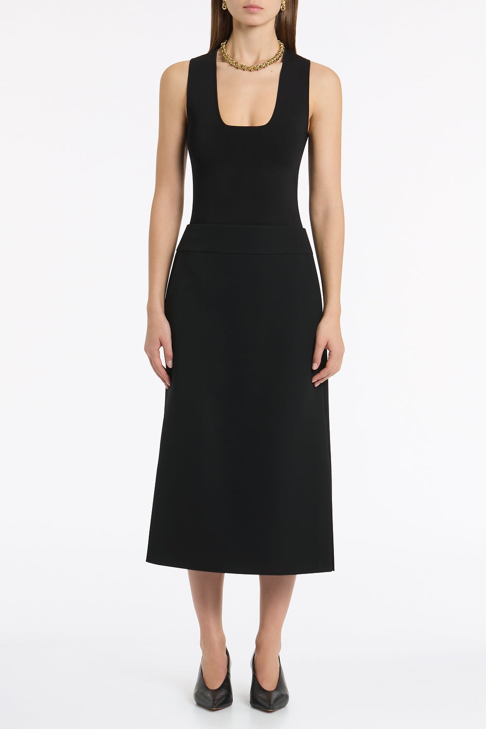 Image of a model wearing Tops. Product name - Black Milano Knit Tank in Black colour by brand - Carla Zampatti