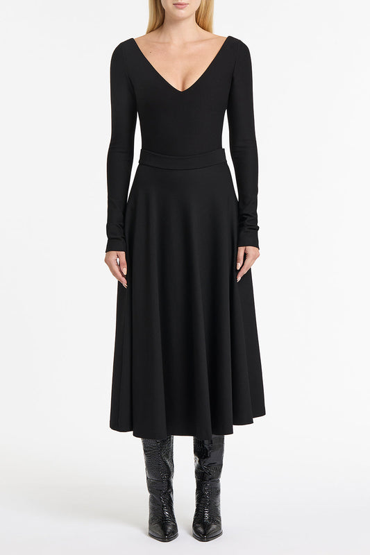 Image of a model wearing Tops. Product name - Black Ponte Deep V Top in Black colour by brand - Carla Zampatti