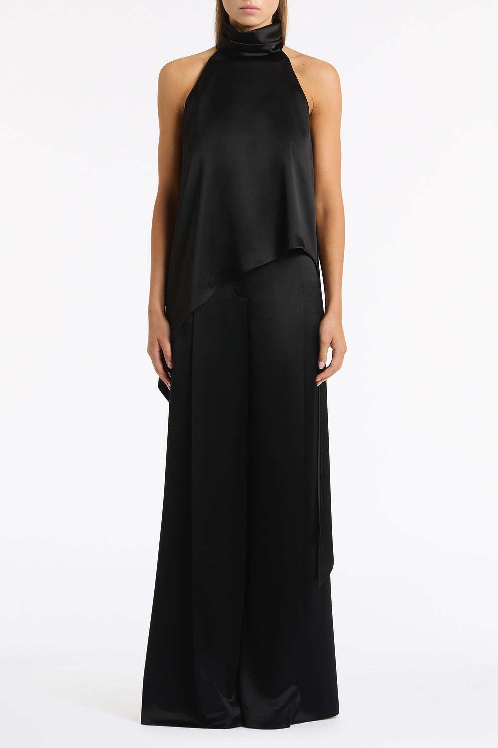 Image of a model wearing Tops. Product name - Black Satin Acetate Draped Asymmetric Top in Black colour by brand - Carla Zampatti