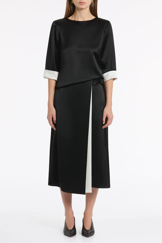 Image of a model wearing Tops. Product name - Black Satin Acetate Relaxed Split Hem Tee in Black colour by brand - Carla Zampatti