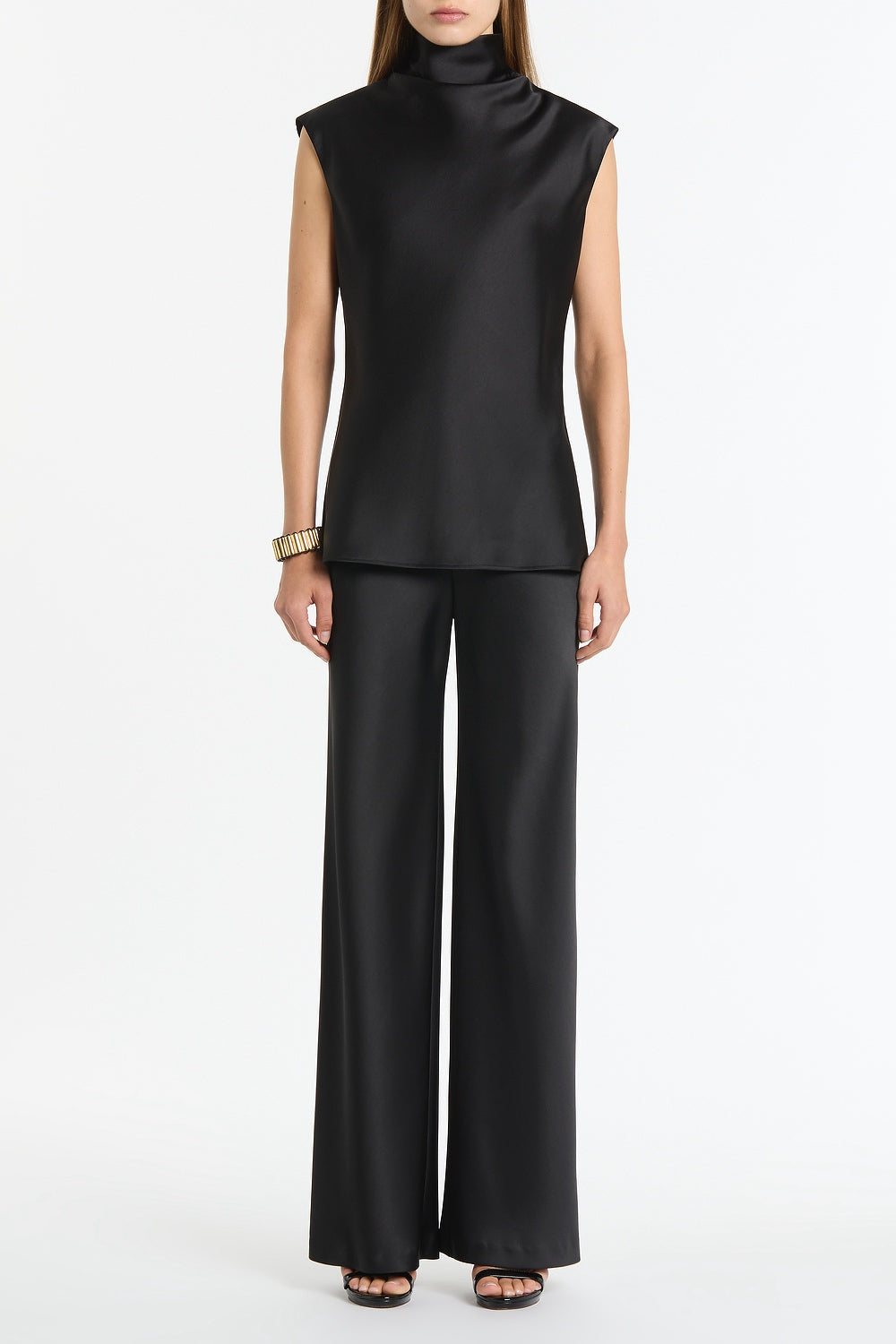 Image of a model wearing Tops. Product name - Black Satin Cap Sleeve Top in Black colour by brand - Carla Zampatti