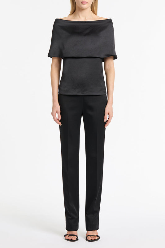 Image of a model wearing Tops. Product name - Black Satin Off Shoulder Top in Black colour by brand - Carla Zampatti