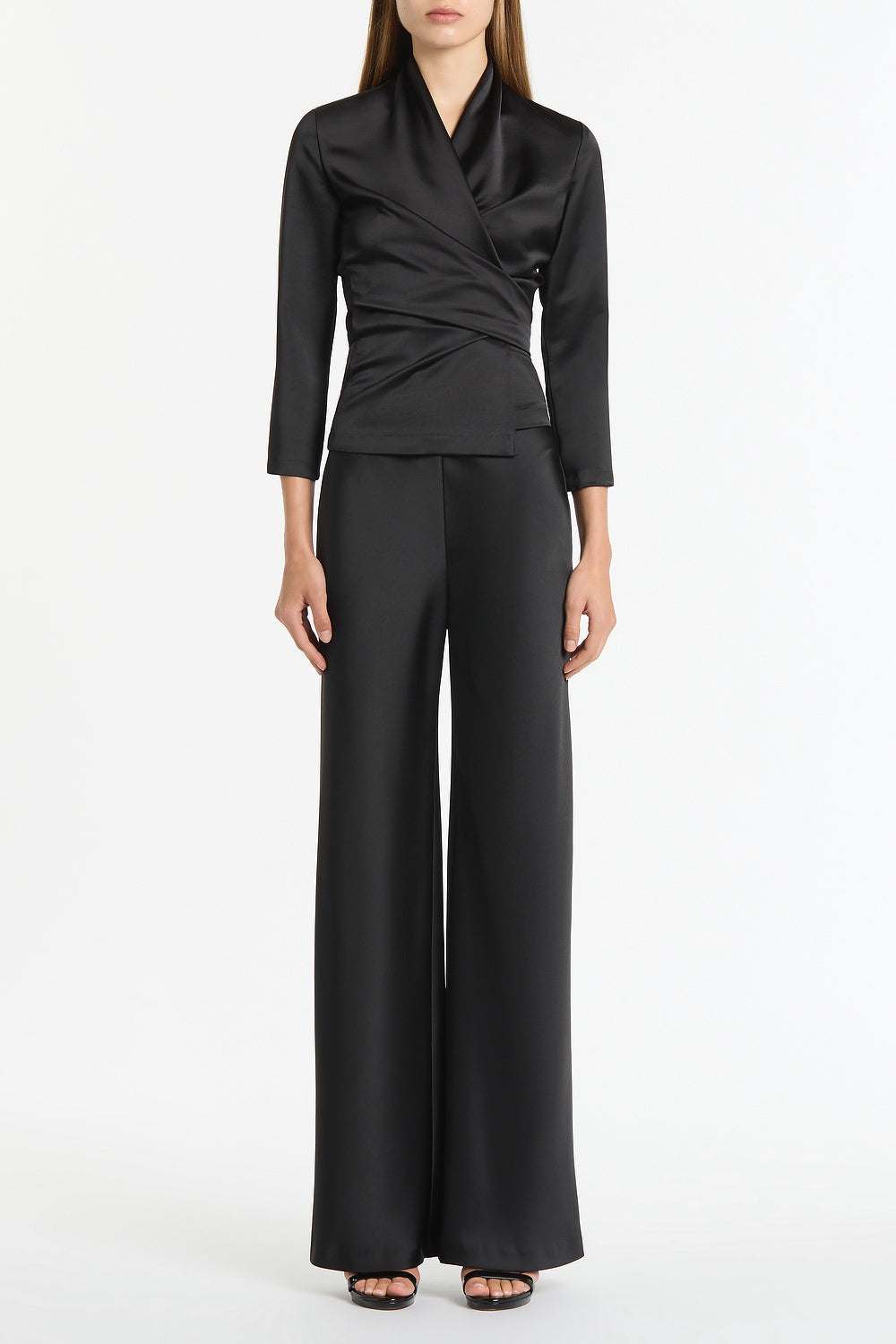 Image of a model wearing Tops. Product name - Black Satin Wrap Top in Black colour by brand - Carla Zampatti