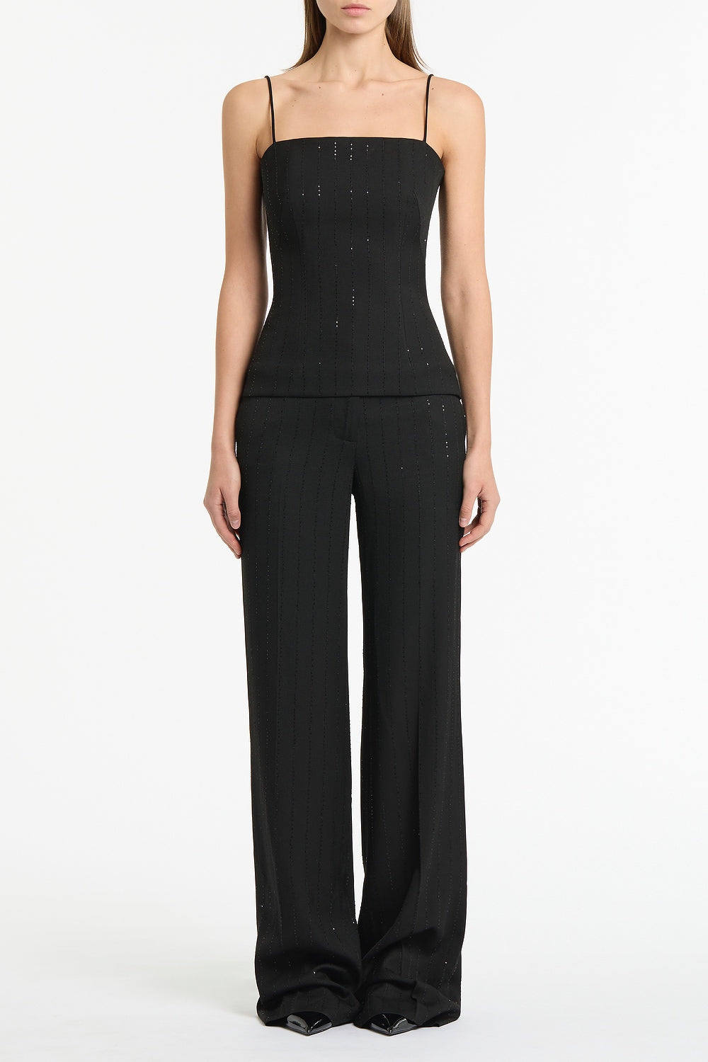 Image of a model wearing Tops. Product name - Black Starlight Twill Bustier Top in Black colour by brand - Carla Zampatti