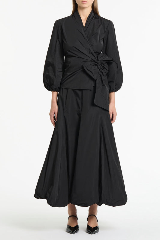 Image of a model wearing Tops. Product name - Black Taffeta Puff Sleeve Wrap Top in Black colour by brand - Carla Zampatti