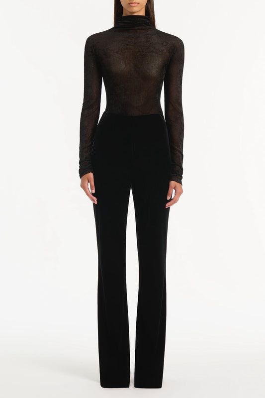 Image of a model wearing Tops. Product name - Black Velvet Mesh Bodysuit in Black colour by brand - Carla Zampatti