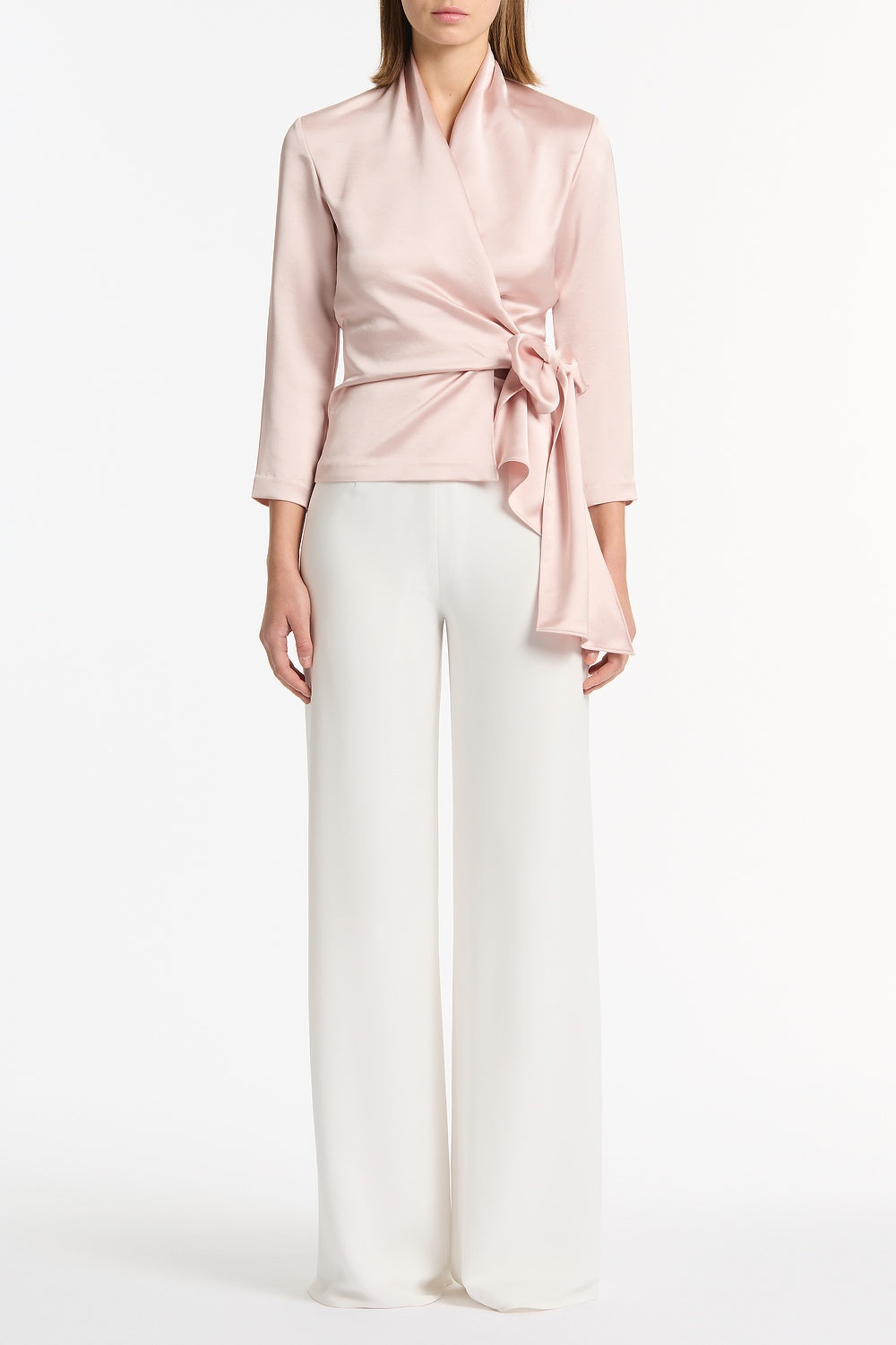 Image of a model wearing Tops. Product name - Blush Lustre Satin Wrap Top in Pink colour by brand - Carla Zampatti