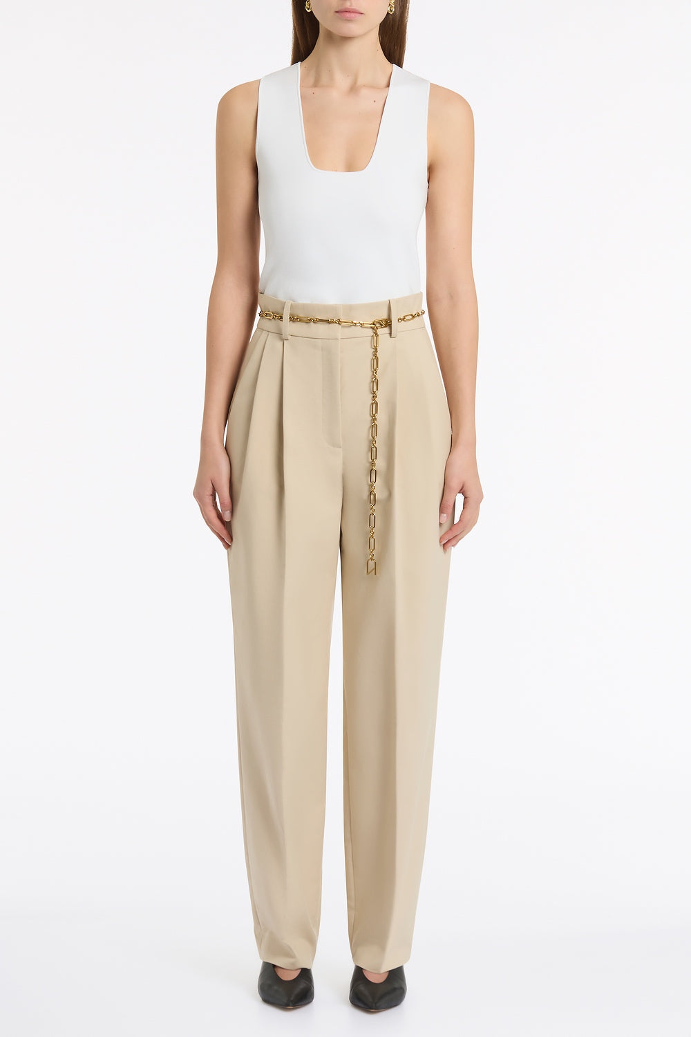 Image of a model wearing Pants. Product name - Bone Luxe Cotton Drill Pleated Pant in Natural colour by brand - Carla Zampatti