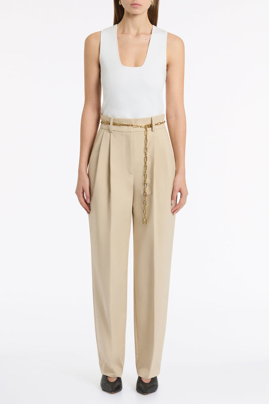Image of a model wearing Pants. Product name - Bone Luxe Cotton Drill Pleated Pant in Natural colour by brand - Carla Zampatti