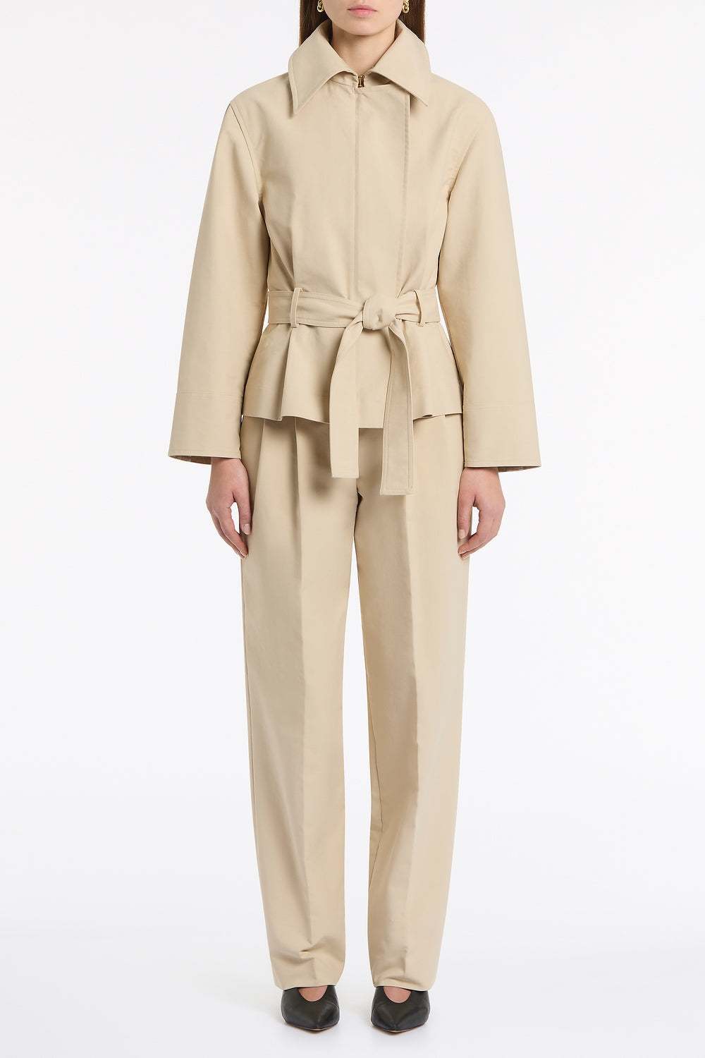 Image of a model wearing Shorts. Product name - Bone Luxe Cotton Drill Short Trench Coat in Natural colour by brand - Carla Zampatti