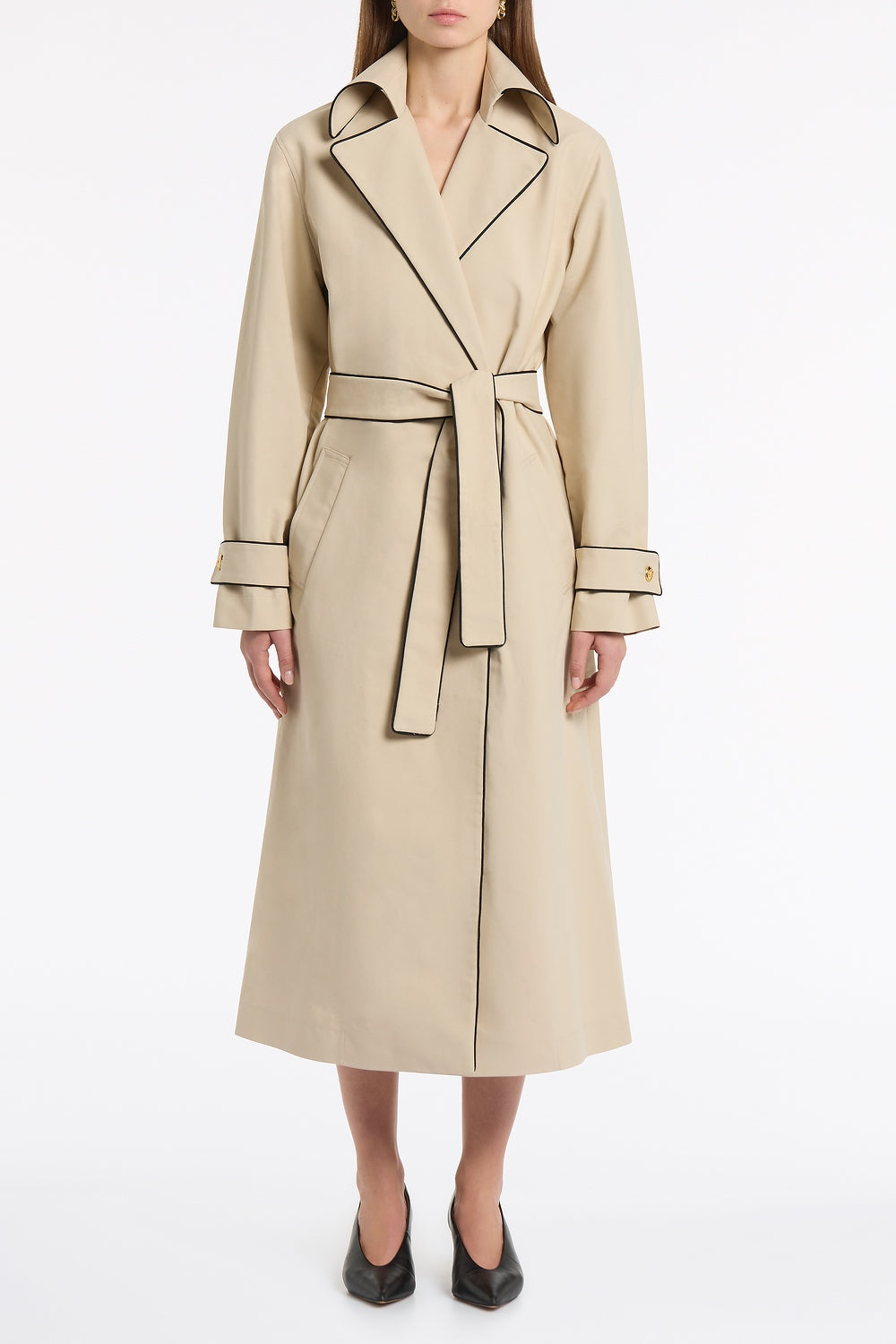 Image of a model wearing Outerwear. Product name - Bone Luxe Cotton Drill Trench Coat in Natural colour by brand - Carla Zampatti