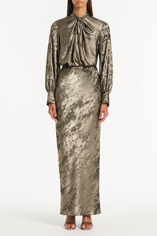 Image of a model wearing Tops. Product name - Burnished Metallic Twist Front Blouse in Bronze colour by brand - Carla Zampatti