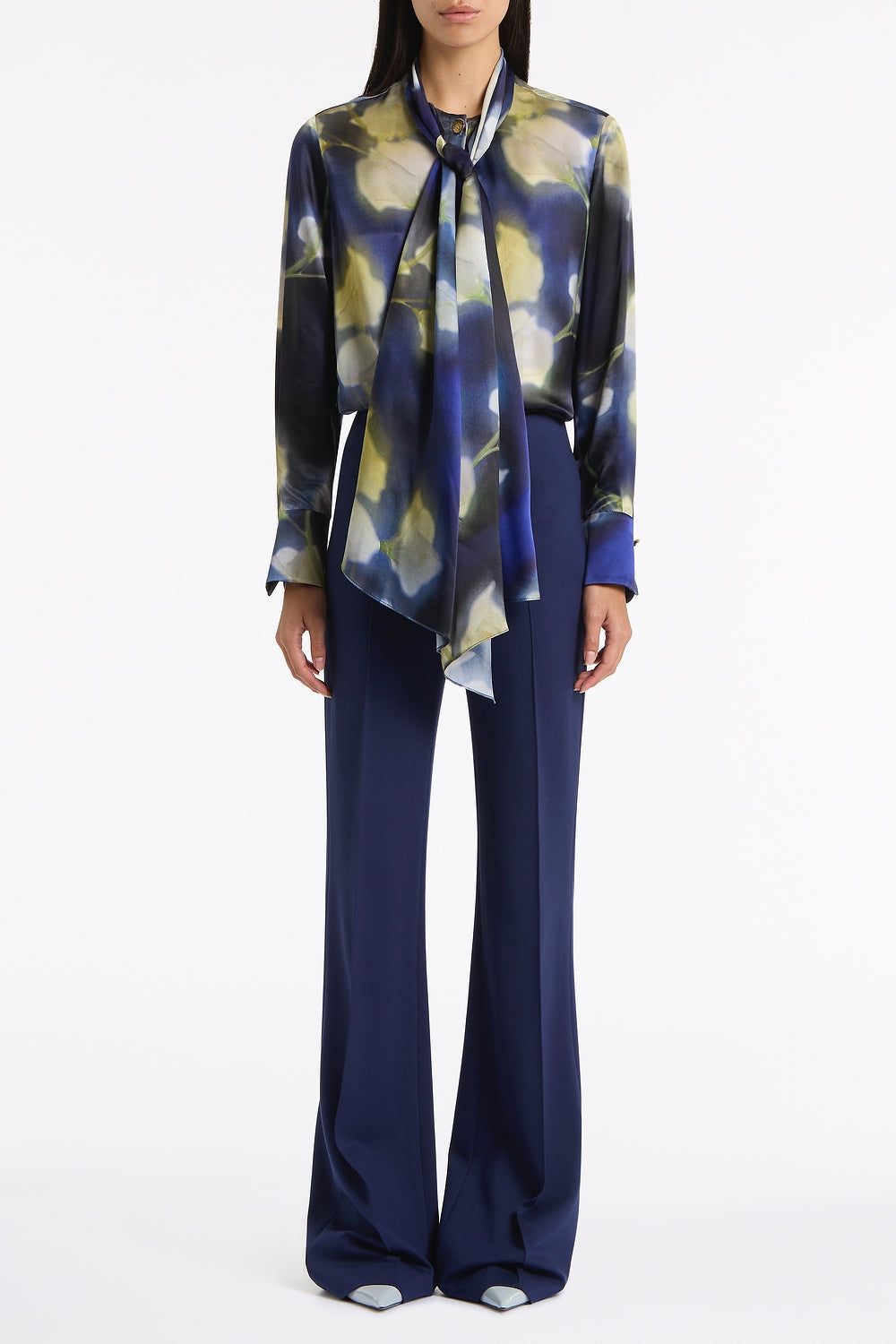 Image of a model wearing Tops. Product name - Calla Lily Silk Viscose Tie Neck Top in Blue colour by brand - Carla Zampatti