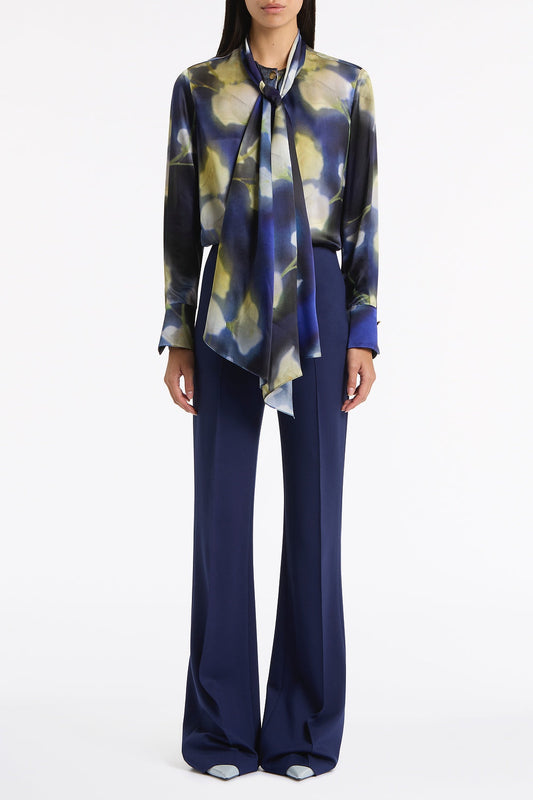 Image of a model wearing Tops. Product name - Calla Lily Silk Viscose Tie Neck Top in Blue colour by brand - Carla Zampatti