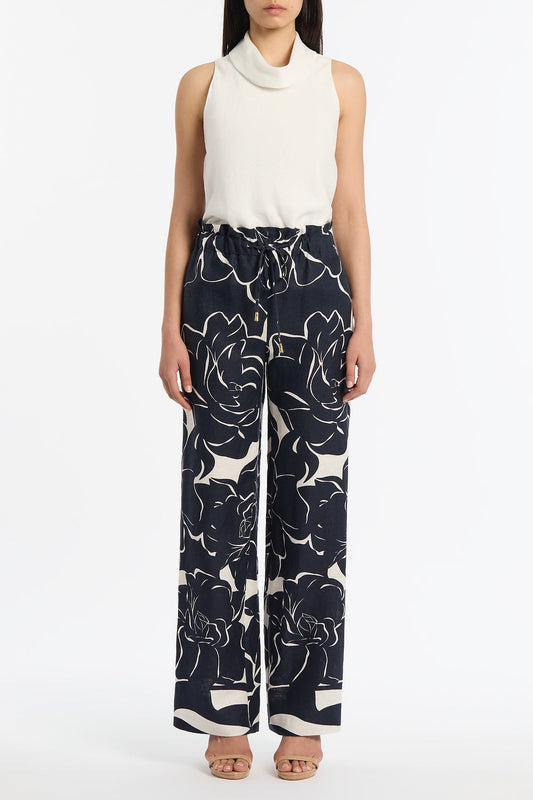 Image of a model wearing Pants. Product name - Celestial Petals Linen Tie Waist Pant in Navy colour by brand - Carla Zampatti