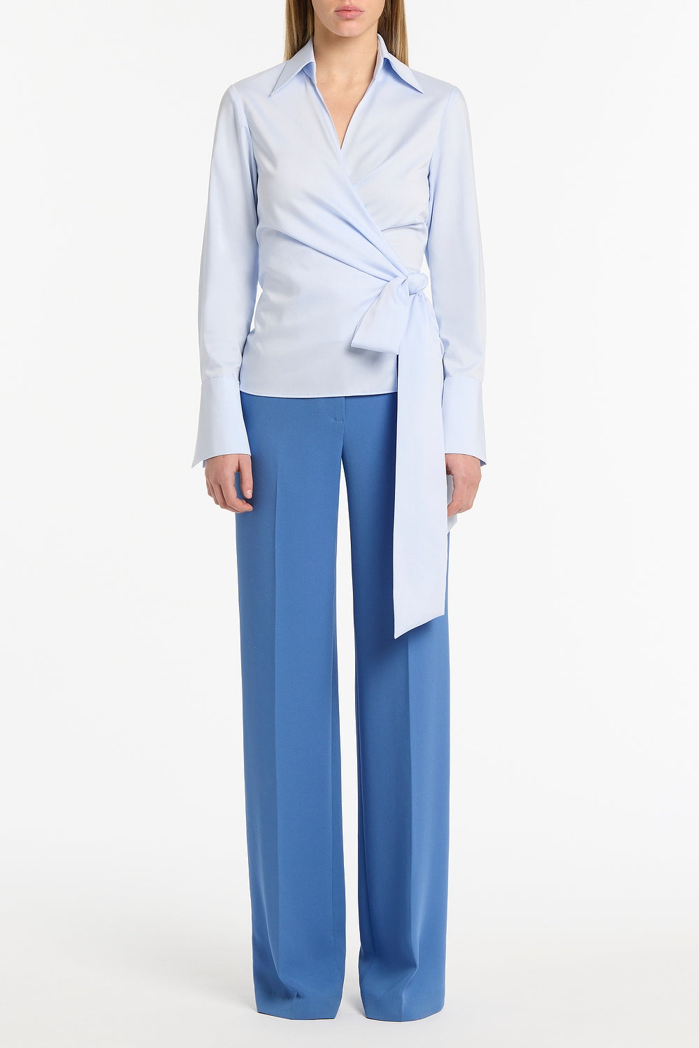 Image of a model wearing Tops. Product name - Chambray Wrap Top in Blue colour by brand - Carla Zampatti