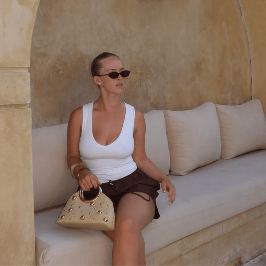 Image of a model wearing Tops. Productname: CHARLOTTE Woven Top Handle in colour by brand - Olga Berg