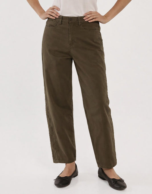 Image of a model wearing Pants. Productname: Barrel Leg Chino - in Khaki Green colour by brand - Betty Basics