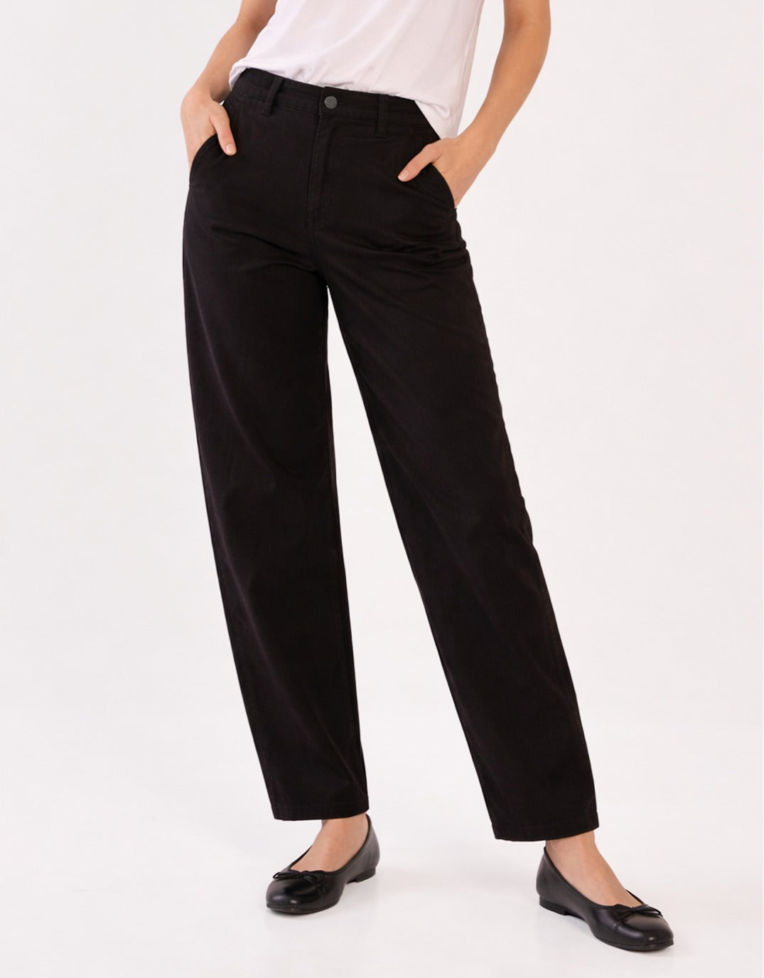 Image of a model wearing Pants. Product name - Barrel Leg Chino Black in Black colour by brand - Betty Basics