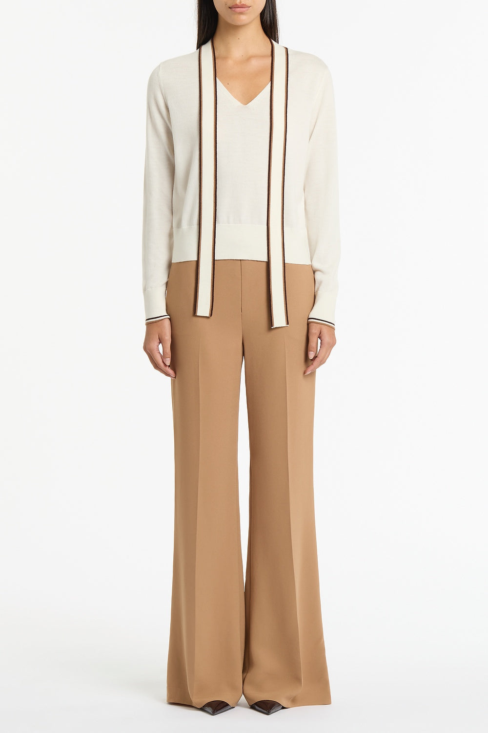 Image of a model wearing Pants. Product name - Cinnamon Crepe Classic Flared Pant in Brown colour by brand - Carla Zampatti