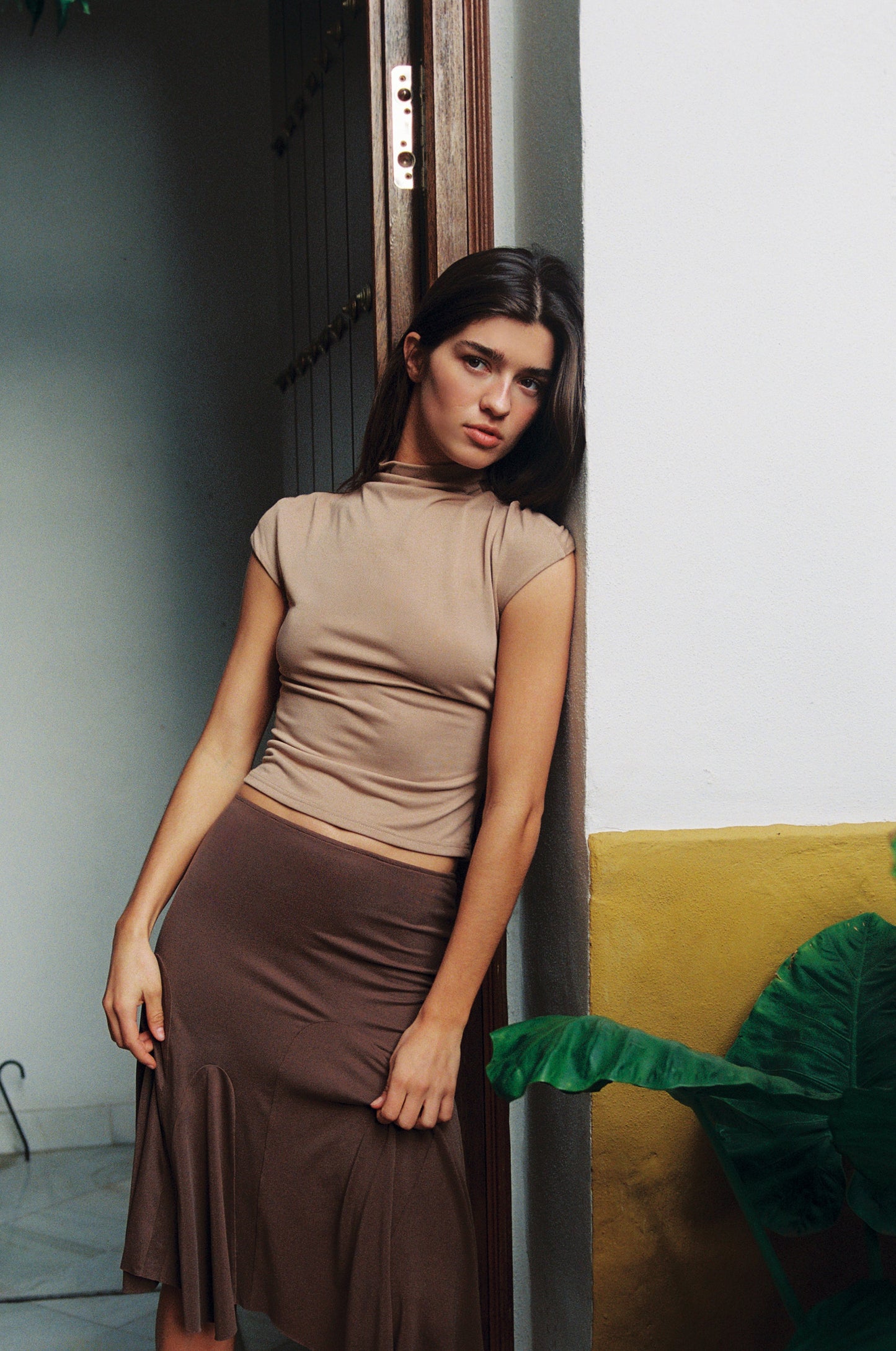 Image of a model wearing Tops. Product name - Cleo Top in Mocha colour by brand - With Jéan