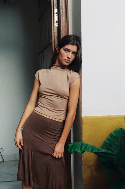 Image of a model wearing Tops. Product name - Cleo Top in Mocha colour by brand - With Jéan