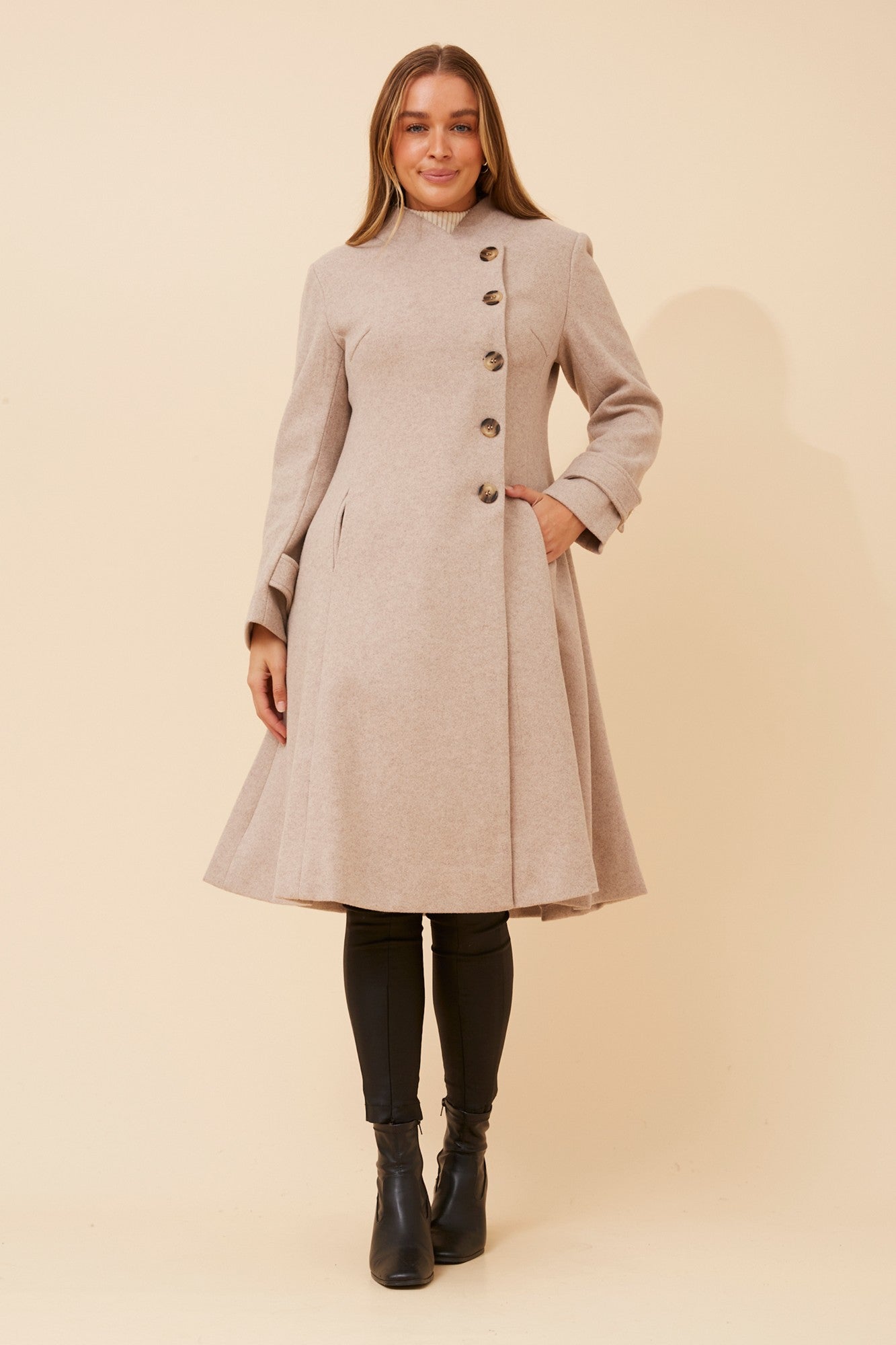 Image of a model wearing Outerwear. Product name - ZENITH FIT AND FLARE COAT in Rose Pink colour by brand - Caroline Morgan Australia