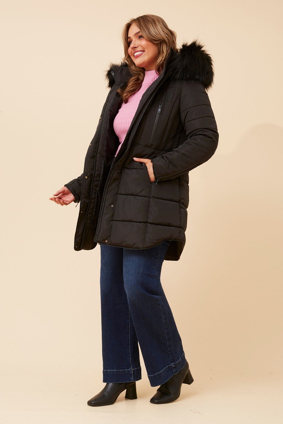 Image of a model wearing Outerwear. Product name - FREYA FAUX FUR PUFFER COAT in Black colour by brand - Caroline Morgan Australia