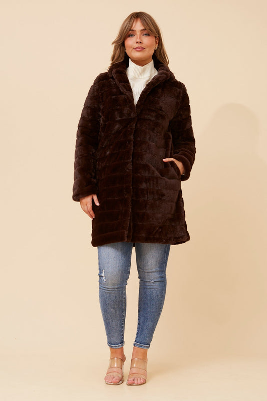 Image of a model wearing Outerwear. Product name - AXELLE FAUX FUR COAT in Beige colour by brand - Caroline Morgan Australia