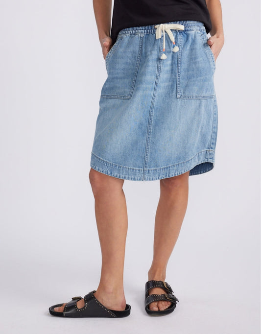 Image of a model wearing Skirts. Product name - Coco Denim Skirt Mid Wash in Mid Wash colour by brand - White & Co.