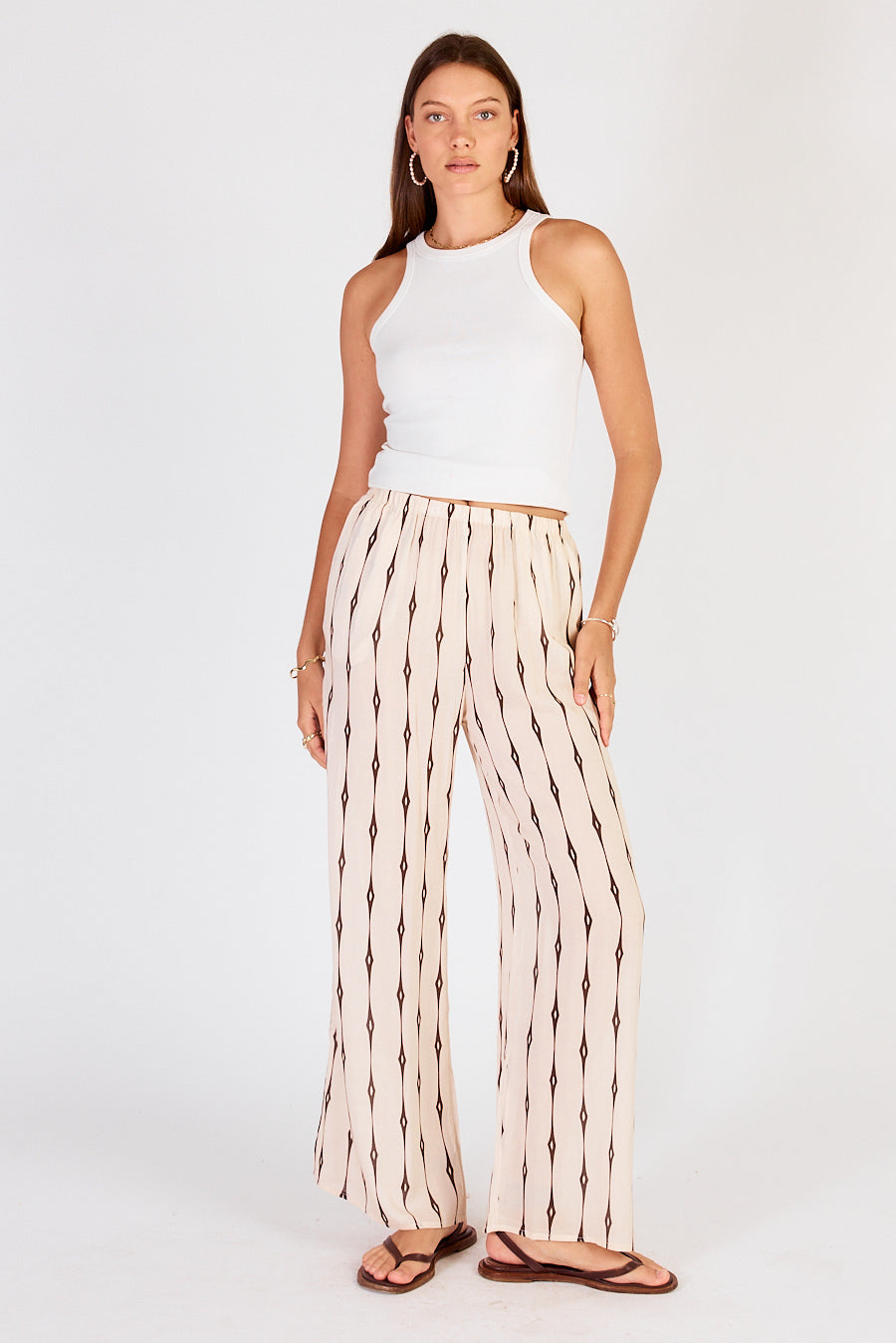 Image of a model wearing Pants. Productname: Cowgirl Surfer Taccia Pant Cream in Cream colour by brand - Cowgirl Surfer