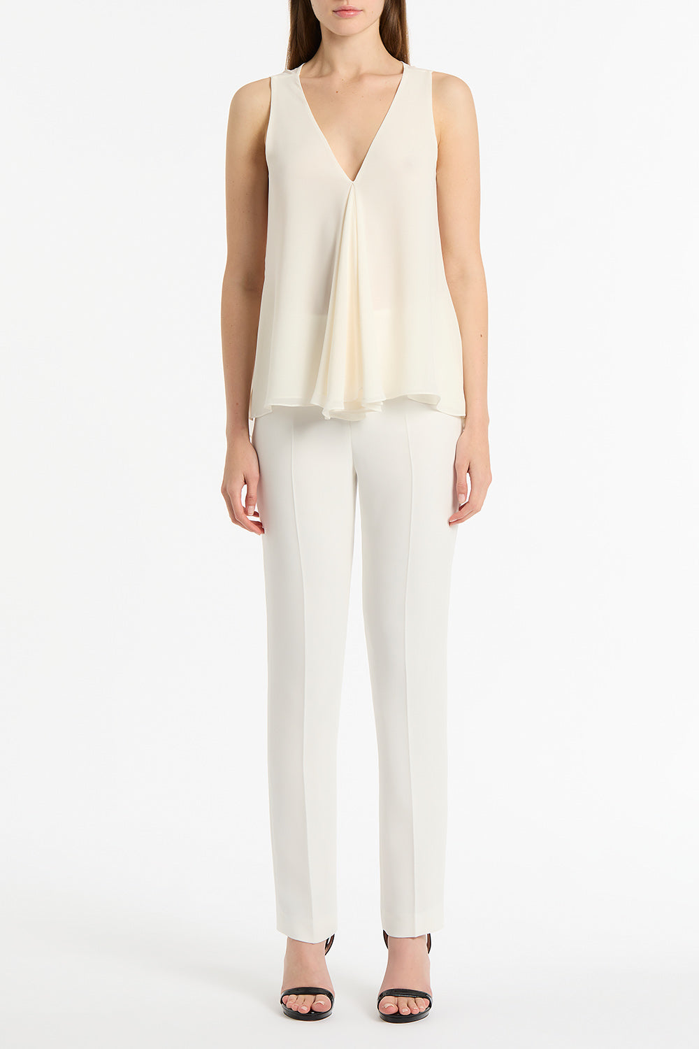 Image of a model wearing Tops. Product name - Cream Georgette Fluted Tank in Cream colour by brand - Carla Zampatti