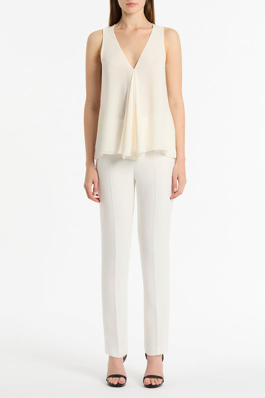 Image of a model wearing Tops. Product name - Cream Georgette Fluted Tank in Cream colour by brand - Carla Zampatti