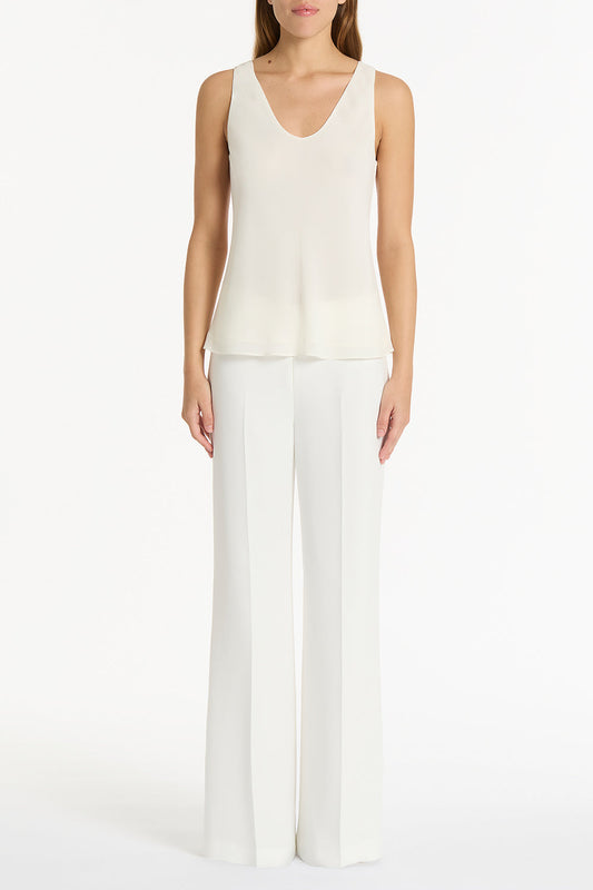 Image of a model wearing Tops. Product name - Cream Georgette Scoop Cami in Cream colour by brand - Carla Zampatti