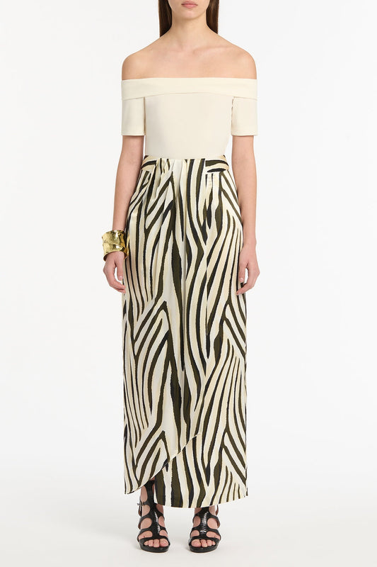 Image of a model wearing Tops. Product name - Cream Jersey Off Shoulder Top in Cream colour by brand - Carla Zampatti