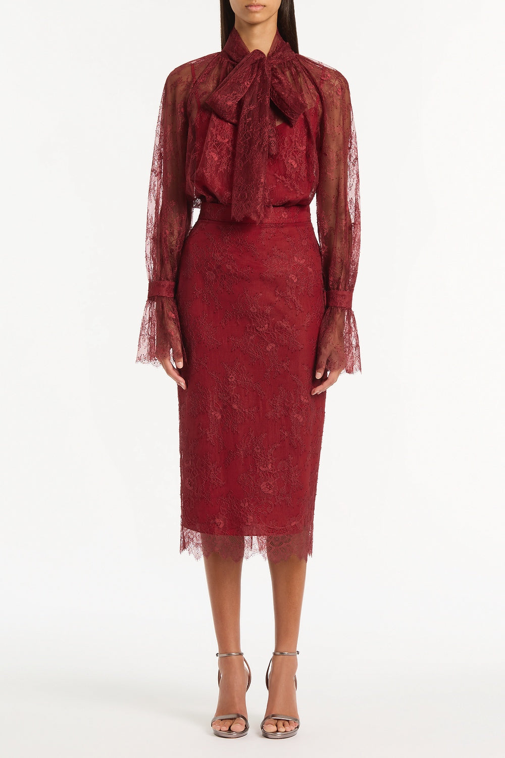 Image of a model wearing Tops. Product name - Dahlia Red Lace Tie Front Blouse in Red colour by brand - Carla Zampatti