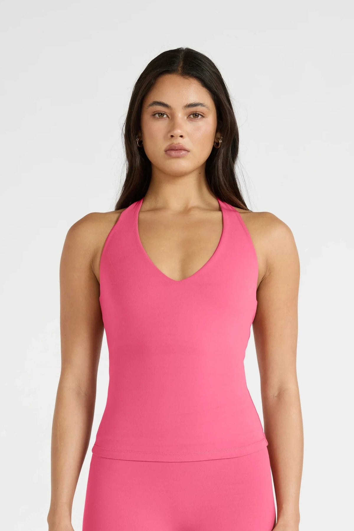 Image of a model wearing Tops. Product name - ALLFENIX CloudCore Plunge Tank in Pink colour by brand - All Fenix