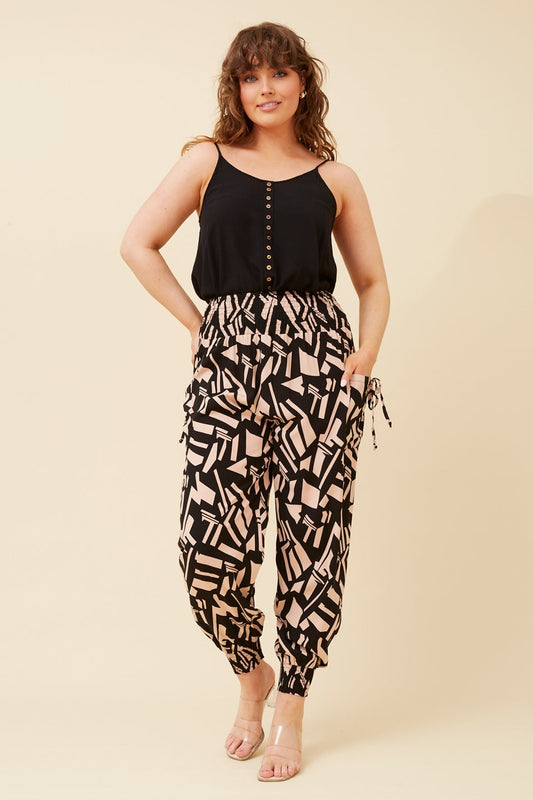 Image of a model wearing Pants. Product name - ABSTRACT PRINT HAREM PANTS in Beige colour by brand - Caroline Morgan Australia