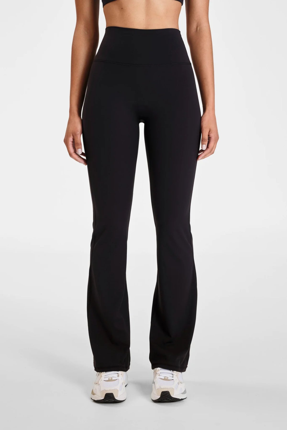Image of a model wearing Pants. Product name - ALLFENIX CloudCore Flared Legging in Red colour by brand - All Fenix