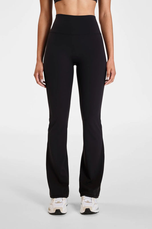Image of a model wearing Pants. Product name - ALLFENIX CloudCore Flared Legging in Red colour by brand - All Fenix