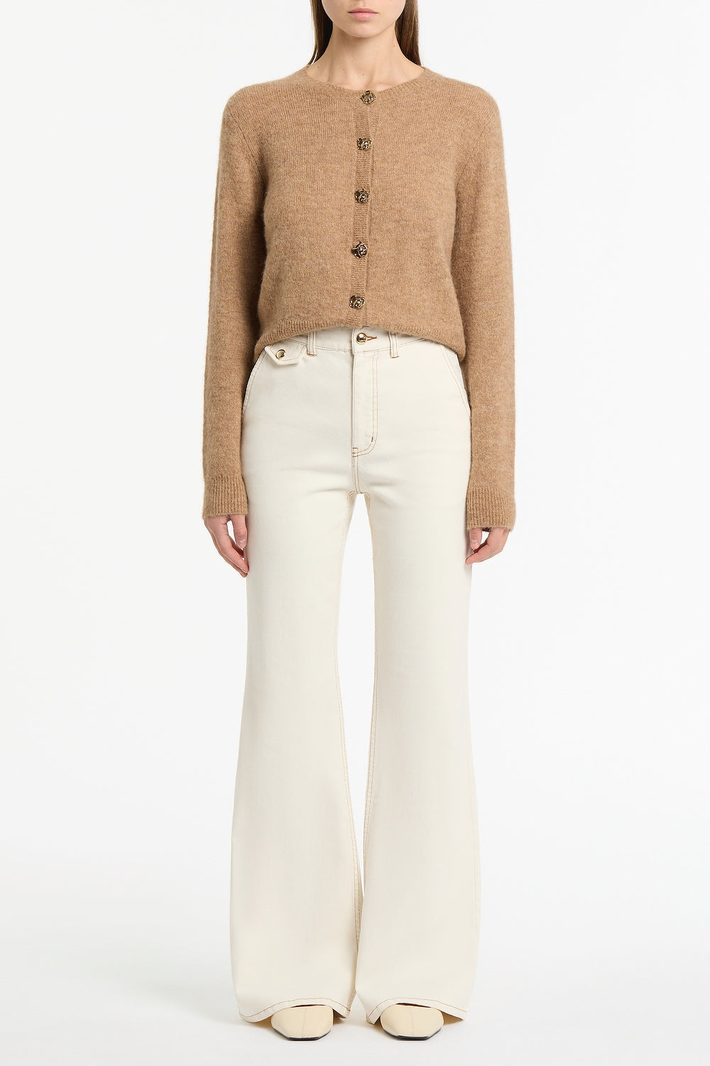 Image of a model wearing Pants. Product name - Ecru Bootleg Denim Jeans in White colour by brand - Carla Zampatti